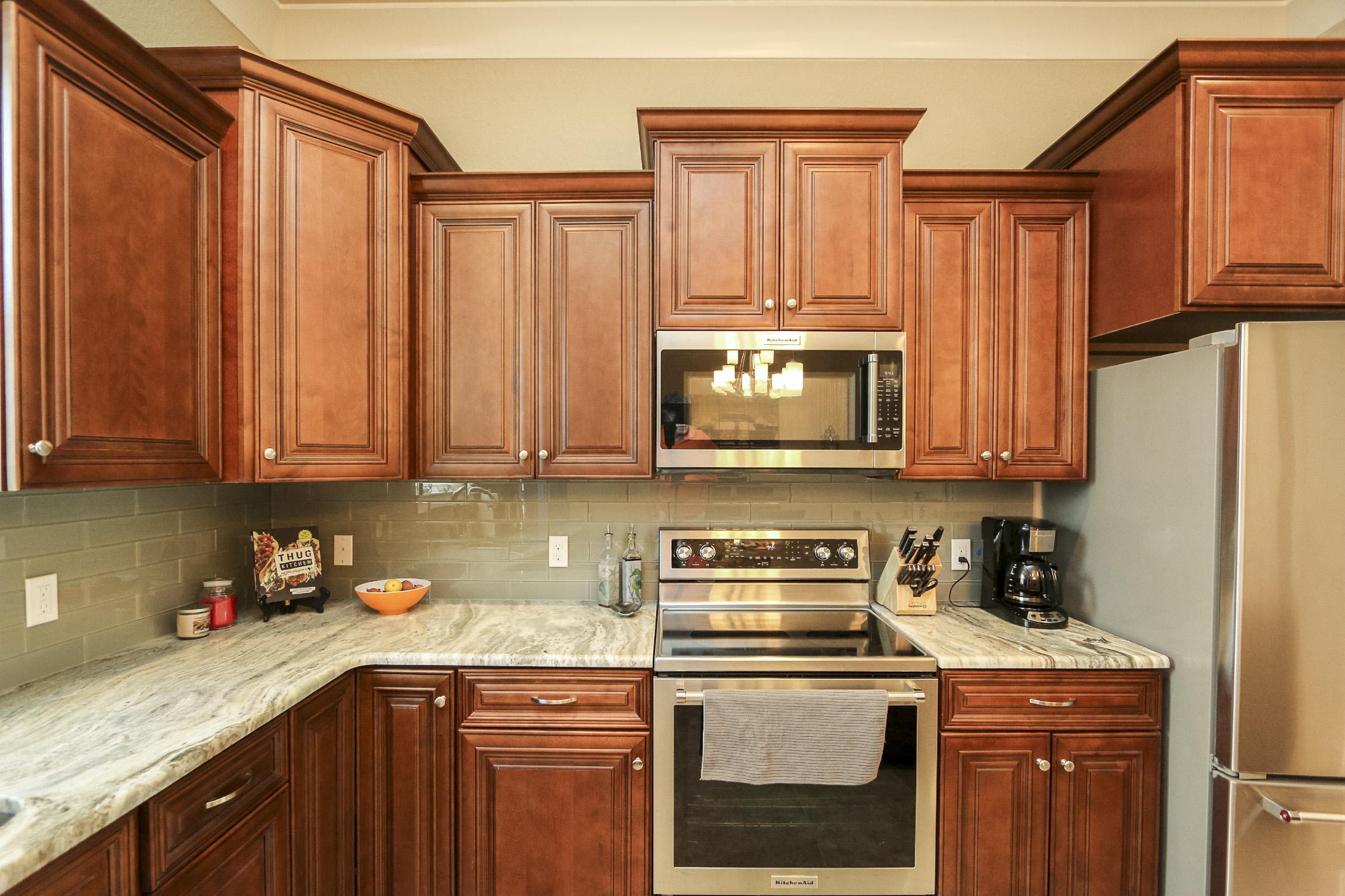 995 Airport Road, Unit 19 Destin, FL 32541 - Photo 17 of 39 a kitchen with stainless steel appliances granite countertop a refrigerator sink and cabinets