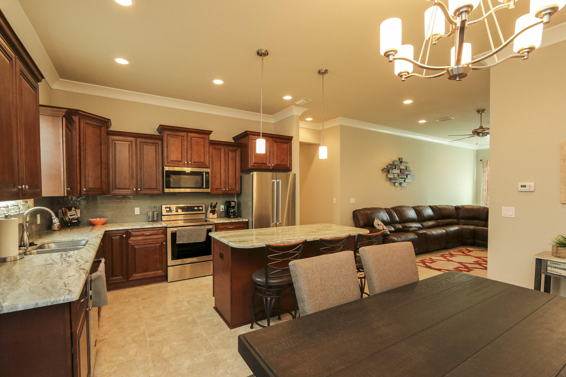 995 Airport Road, Unit 19 Destin, FL 32541 - Photo 2 of 39 a large kitchen with kitchen island granite countertop a sink a stove and a refrigerator