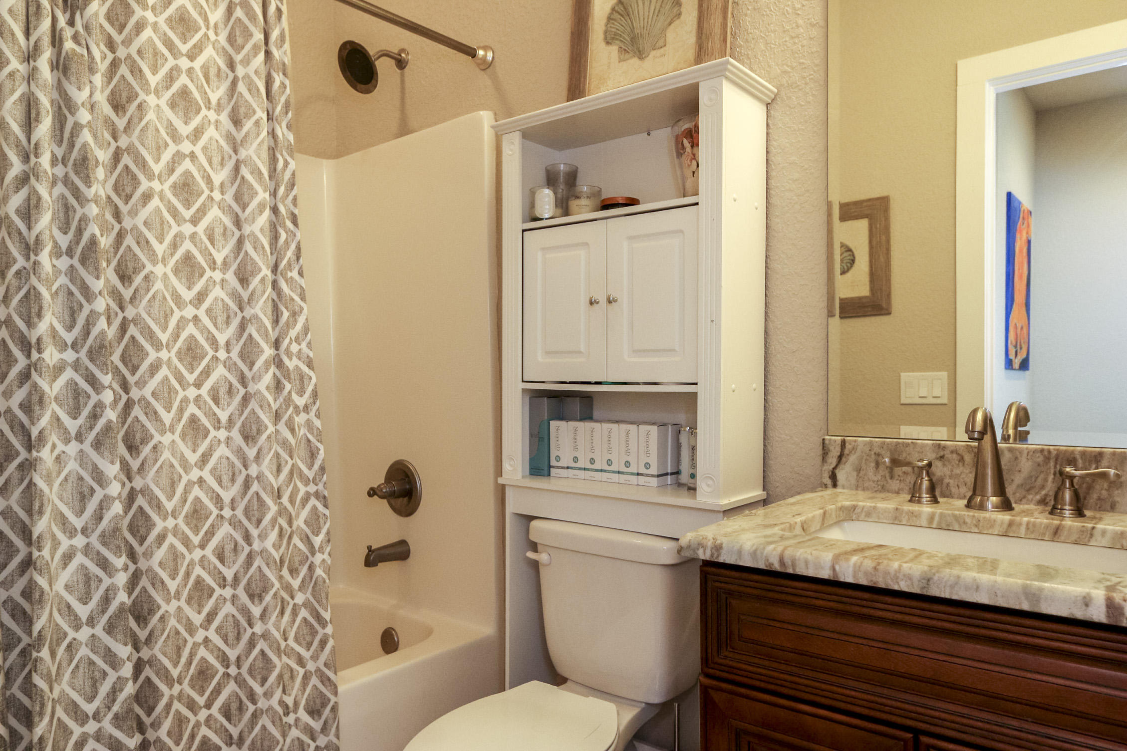 995 Airport Road, Unit 19 Destin, FL 32541 - Photo 25 of 39 a bathroom with a granite countertop sink toilet and shower