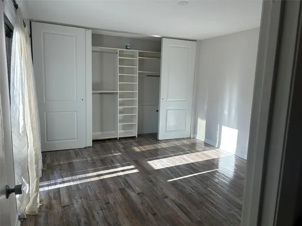 a view of wooden floor and windows in a room