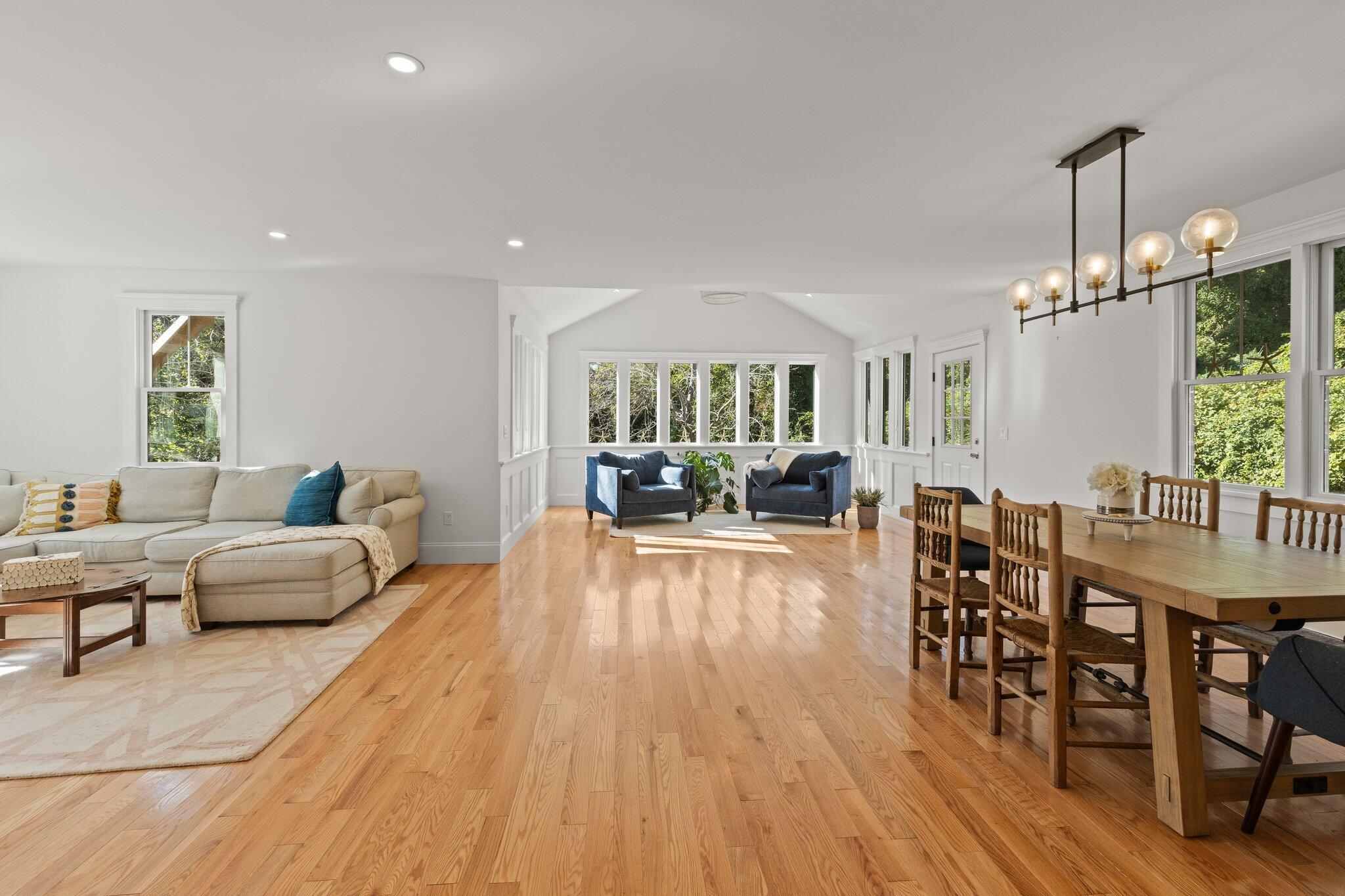 12 Jonathan Lane Sandwich, MA 02563 - Photo 13 of 57 a living room with furniture dining table a chandelier and a wooden floor