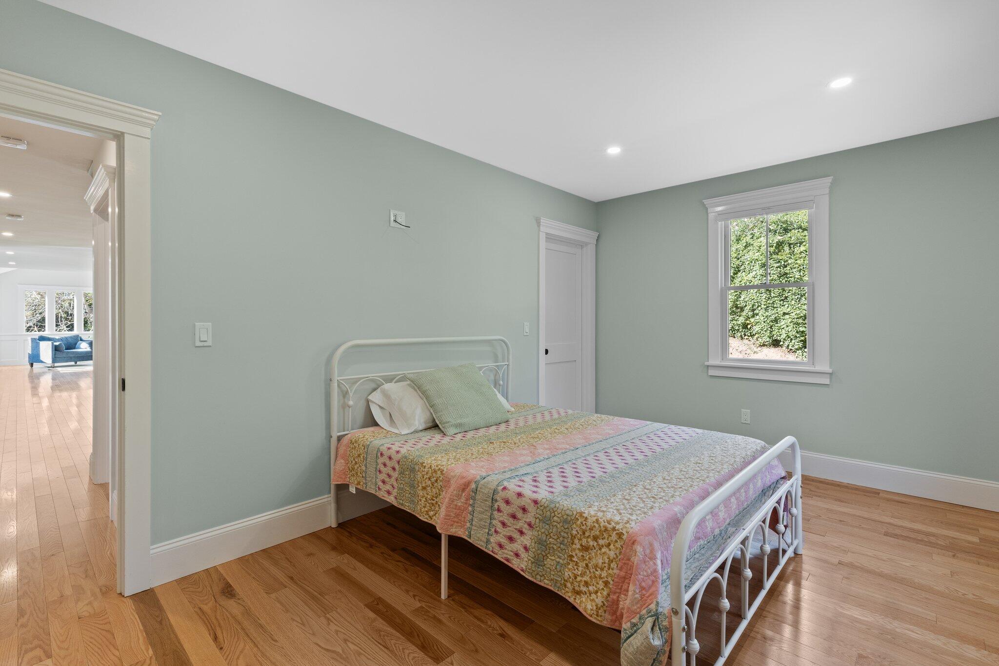 12 Jonathan Lane Sandwich, MA 02563 - Photo 27 of 57 a bedroom with a bed and wooden floor