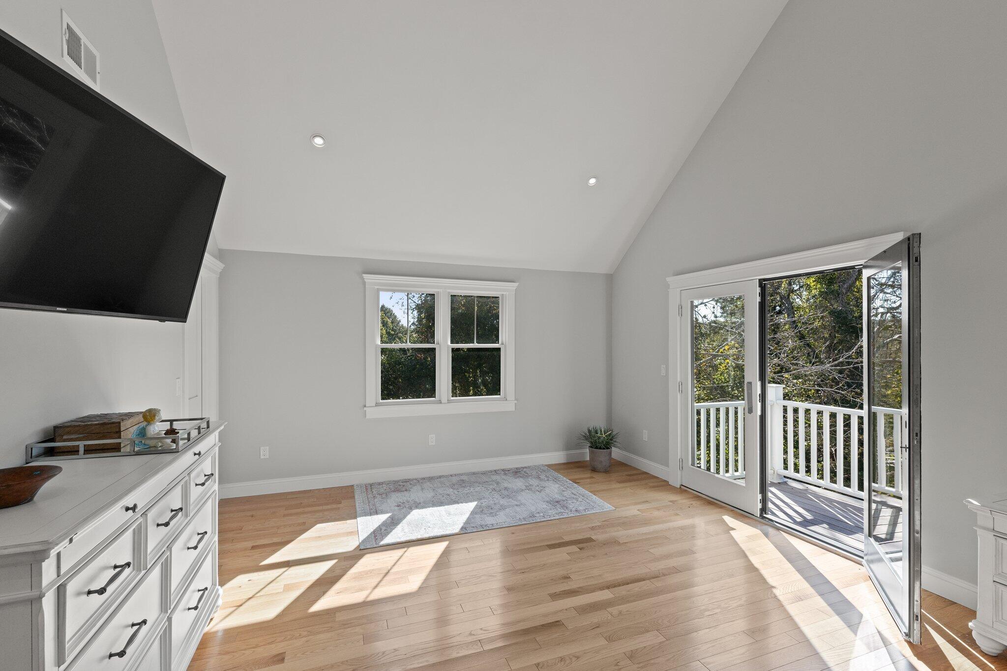 12 Jonathan Lane Sandwich, MA 02563 - Photo 31 of 57 a bedroom with a bed and a flat tv screen on the dresser