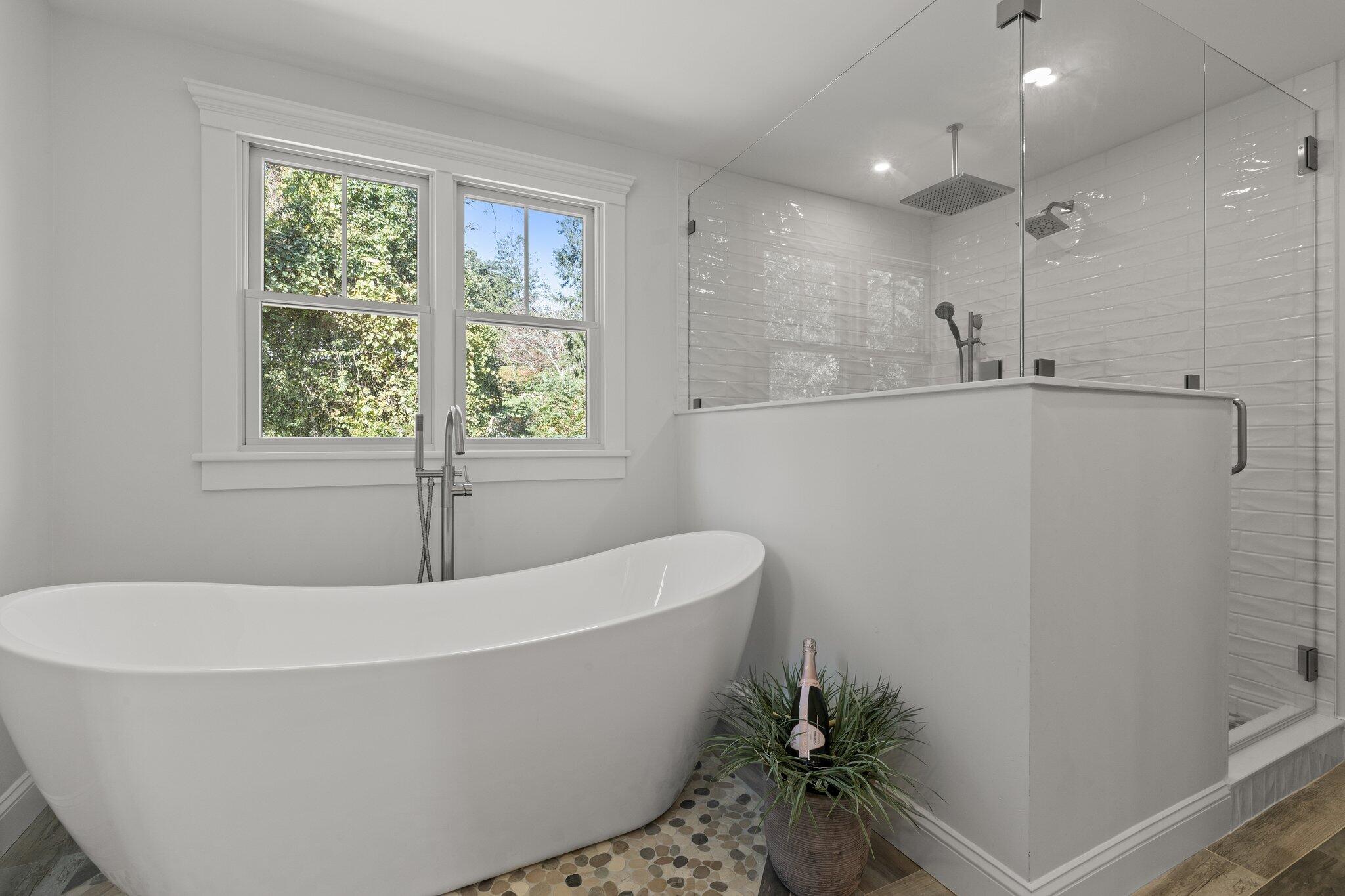 12 Jonathan Lane Sandwich, MA 02563 - Photo 37 of 57 a white bath tub sitting in a bathroom next to a window