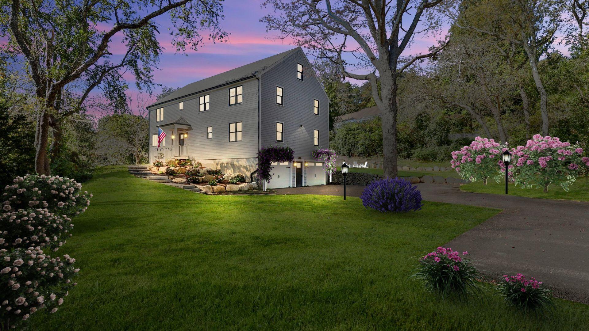 12 Jonathan Lane Sandwich, MA 02563 - Photo 6 of 57 a front view of a house with a garden