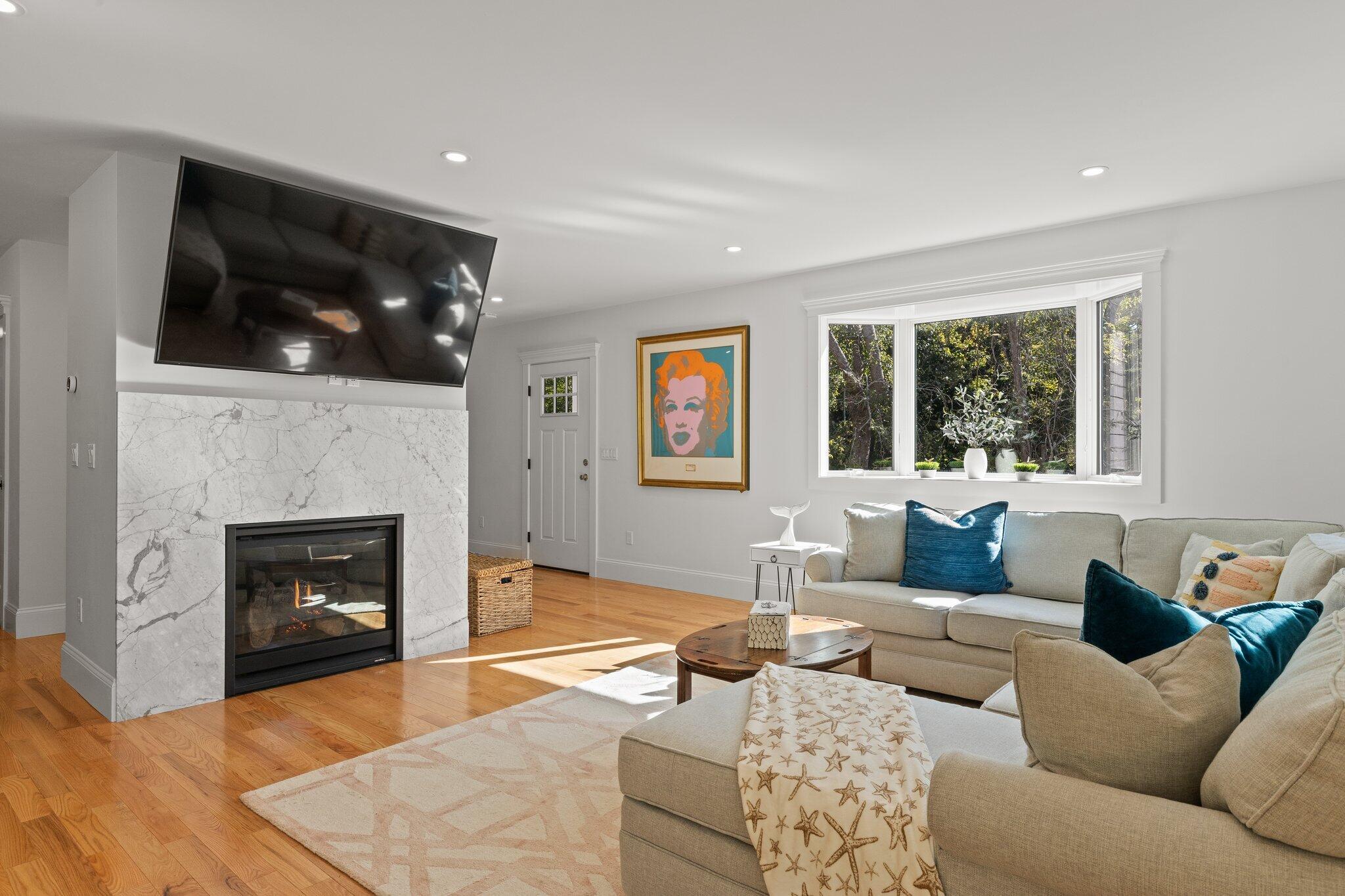 12 Jonathan Lane Sandwich, MA 02563 - Photo 9 of 57 a living room with furniture and a fireplace