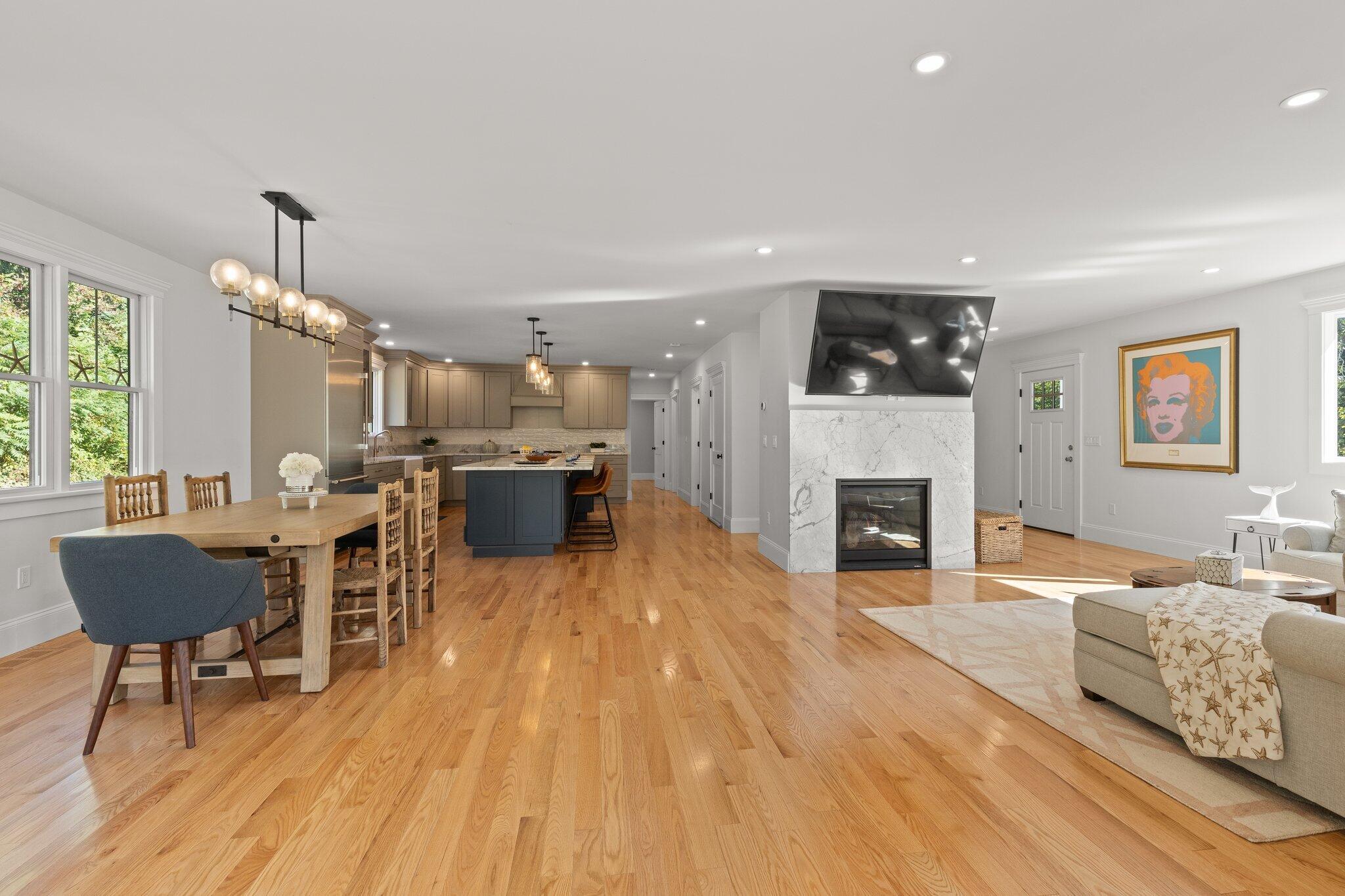 12 Jonathan Lane Sandwich, MA 02563 - Photo 10 of 57 a living room with furniture a fireplace and a table