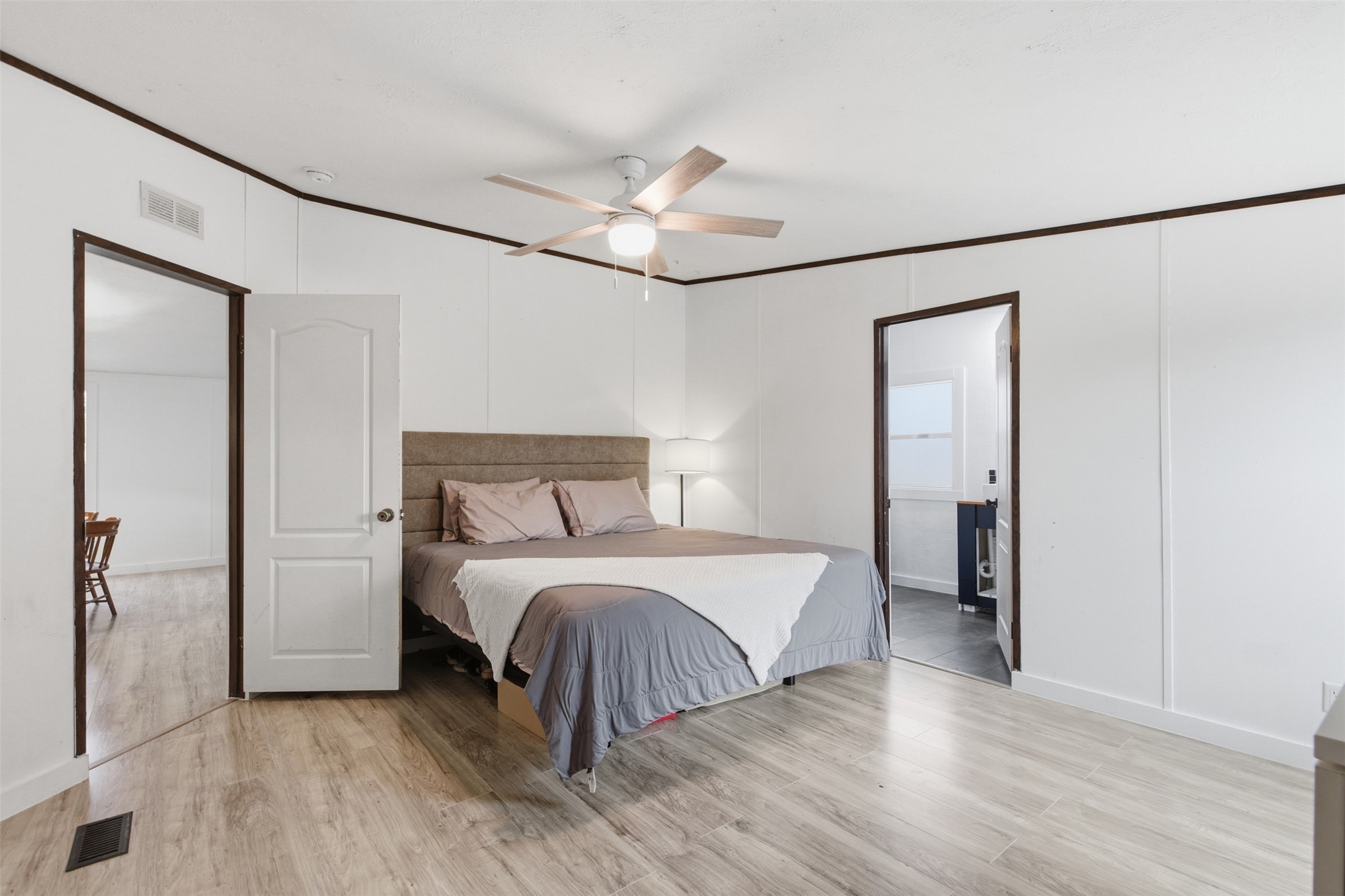 580 Railyard Drive Kyle, TX 78640 - Photo 11 of 20 Bedroom featuring light-toned flooring, white walls, and a ceiling fan