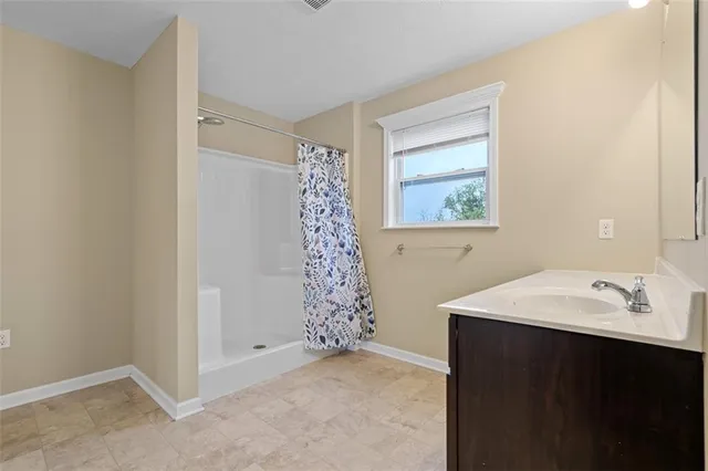 a bathroom with a sink and a shower