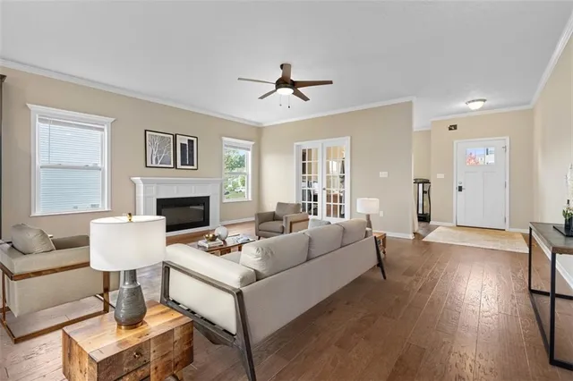 a living room with furniture a fireplace and a table