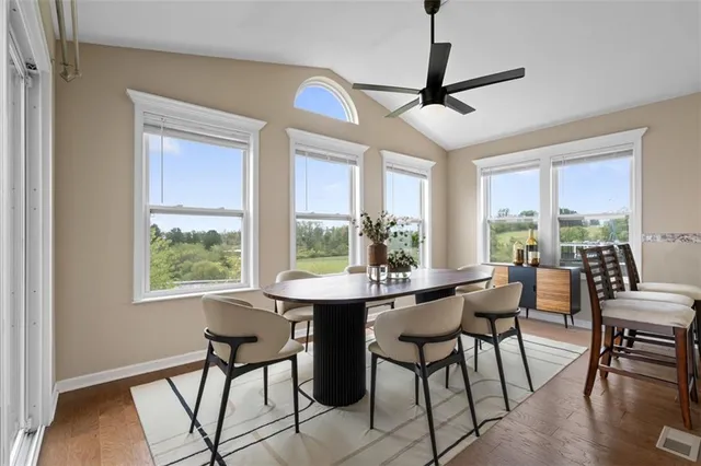 a dining room with furniture window and wooden floor