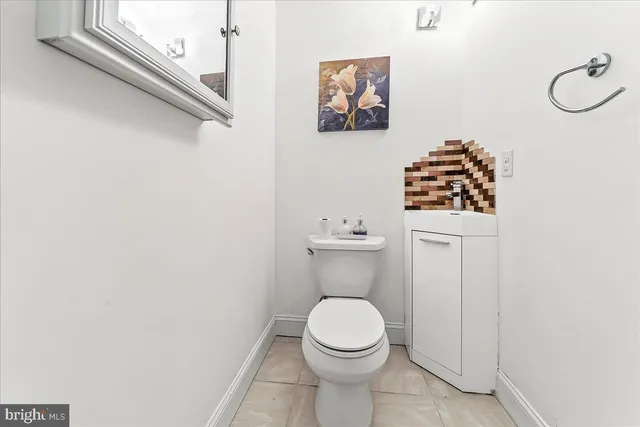a white toilet sitting next to a bathroom sink