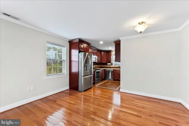 a kitchen with stainless steel appliances a refrigerator and a stove top oven
