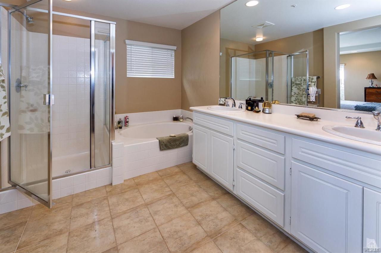 2102 Ribera Drive Oxnard, CA 93030 - Photo 11 of 18 a bathroom with a tub sink and mirror
