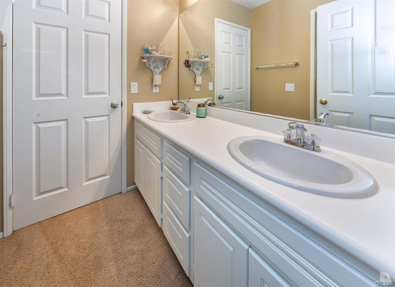 2102 Ribera Drive Oxnard, CA 93030 - Photo 15 of 18 a bathroom with a double vanity sink and a mirror