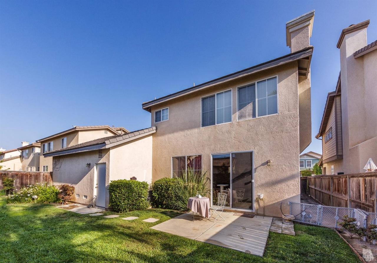 2102 Ribera Drive Oxnard, CA 93030 - Photo 18 of 18 a front view of a house with a yard and garage