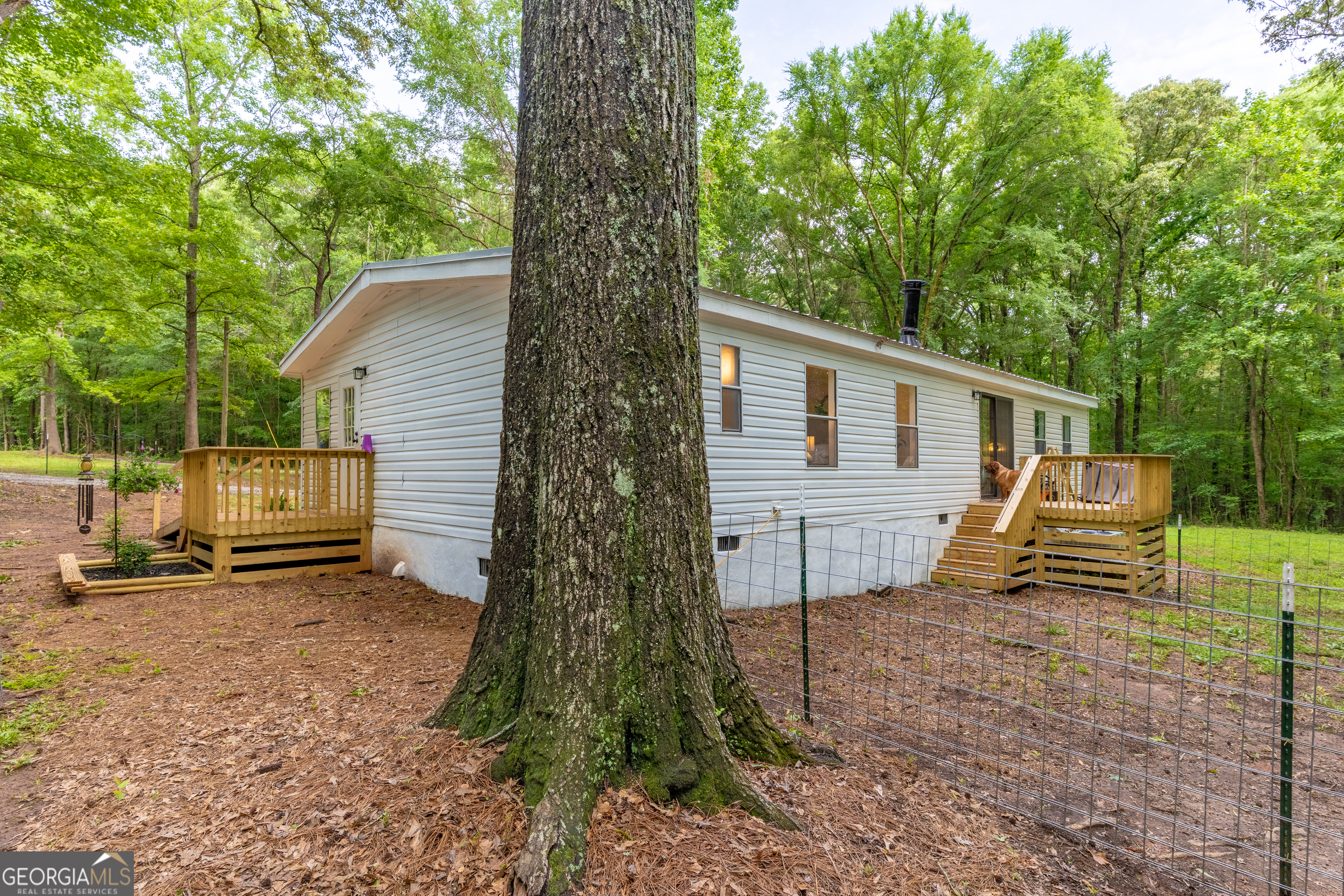 452 Aikenton Road Monticello, GA 31064 - Photo 37 of 47 a view of a house with backyard and a tree