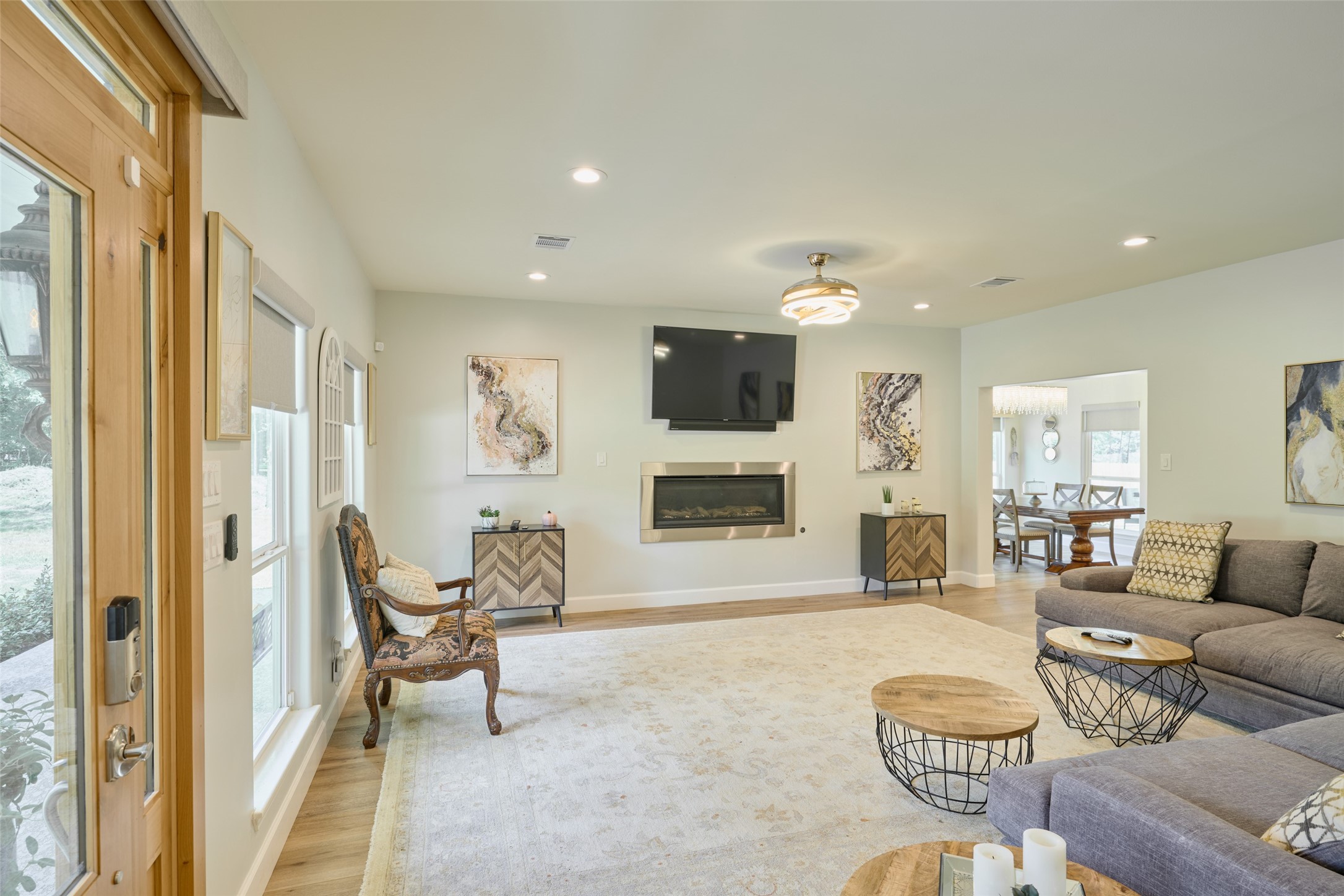2218 Honea Egypt Road Magnolia, TX 77354 - Photo 26 of 50 Inviting and spacious family room with modern fireplace, abundant natural light, and seamless flow into the dining area.