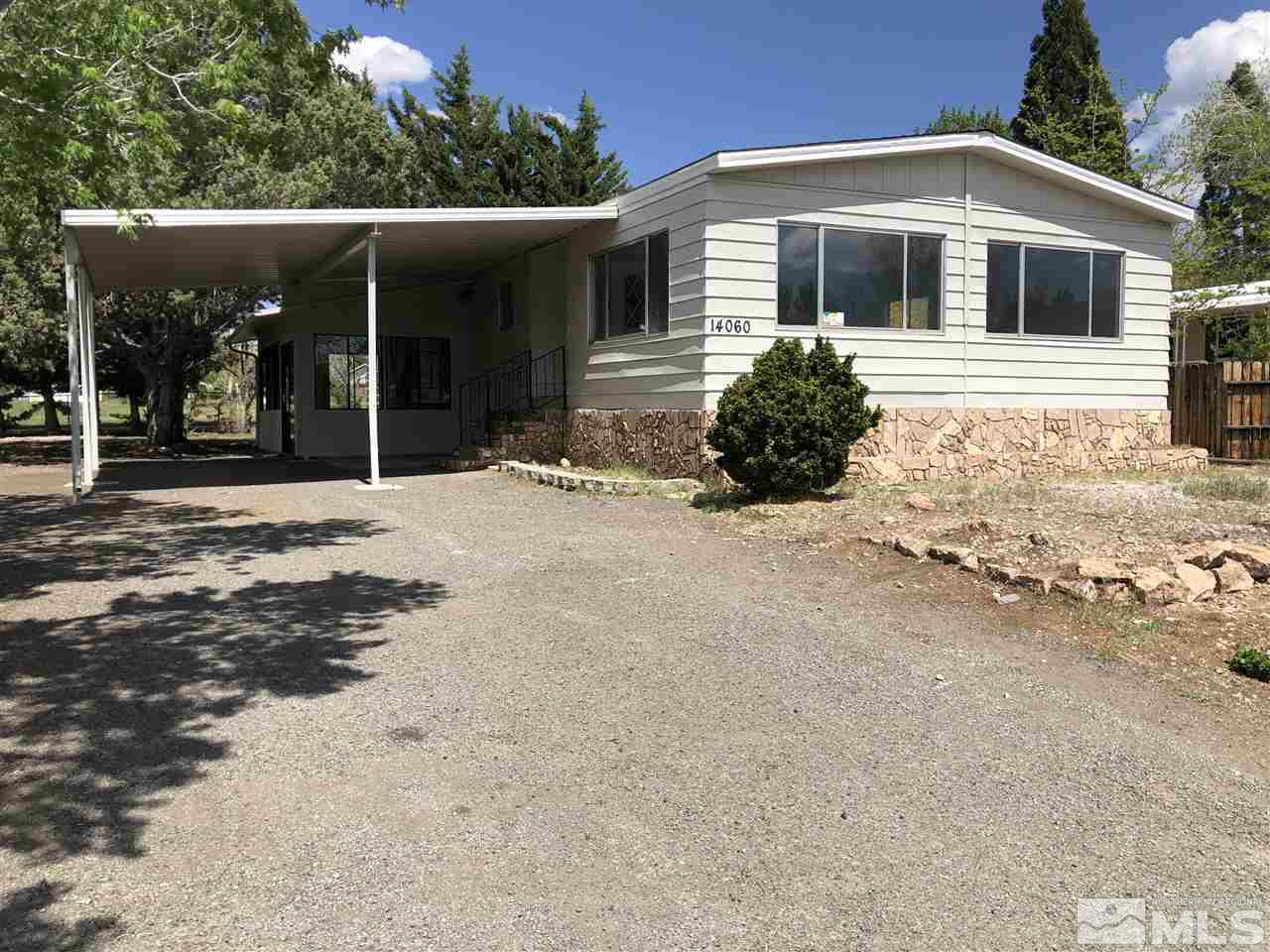 14060 Rhyolite Circle, Unit 89521 Reno, NV 89521 - Photo 1 of 18 a front view of a house with a yard