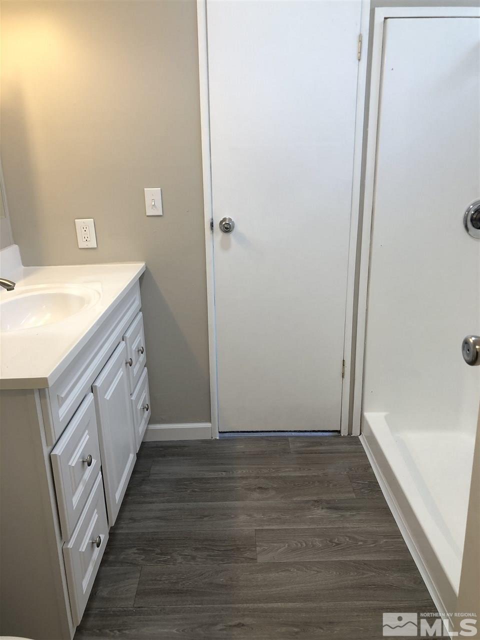 14060 Rhyolite Circle, Unit 89521 Reno, NV 89521 - Photo 13 of 18 a bathroom with a granite countertop sink and a mirror