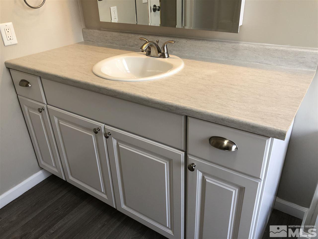 14060 Rhyolite Circle, Unit 89521 Reno, NV 89521 - Photo 10 of 18 a bathroom with a sink and a mirror