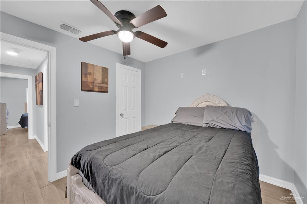 405 East Guerra Street Rio Grande City, TX 78582 - Photo 20 of 33 Bedroom with light wood-type flooring, baseboards, and ceiling fan