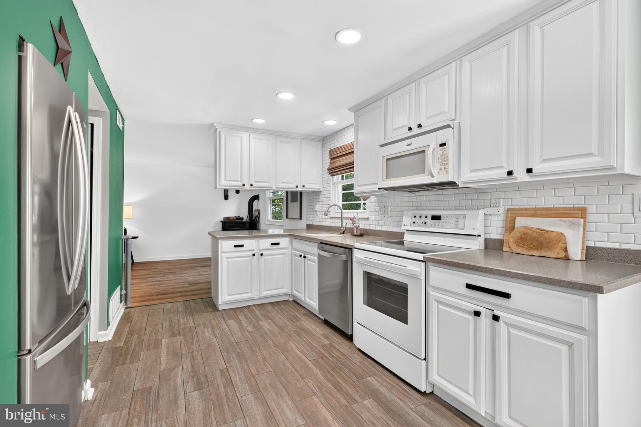 607 Prospect Avenue Morrisville, PA 19067 - Photo 9 of 35 a kitchen with white cabinets and white appliances