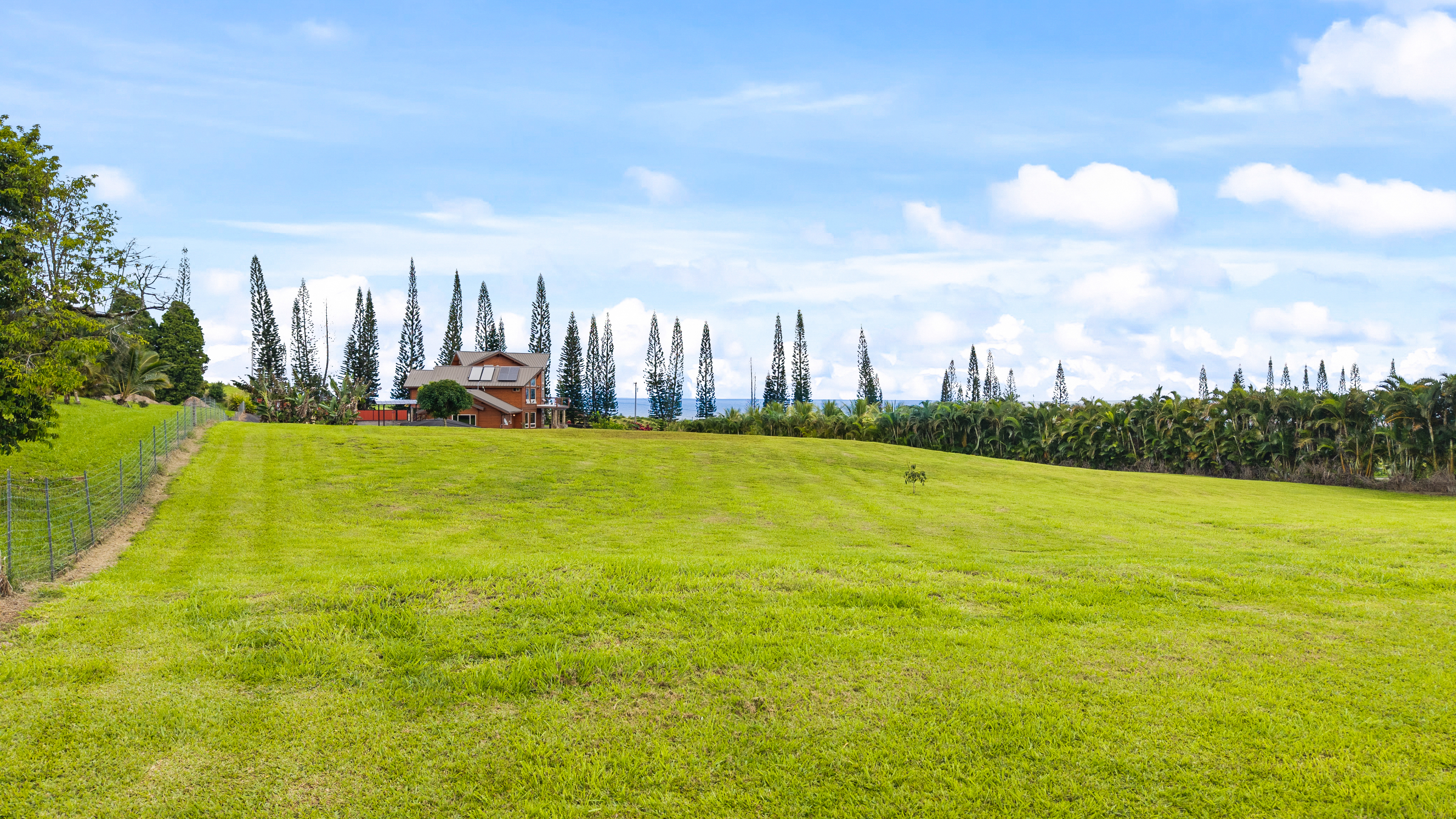 28-425 Overpass Road Pepeekeo, HI 96783 - Photo 16 of 30 a view of a swimming pool with an outdoor seating and yard