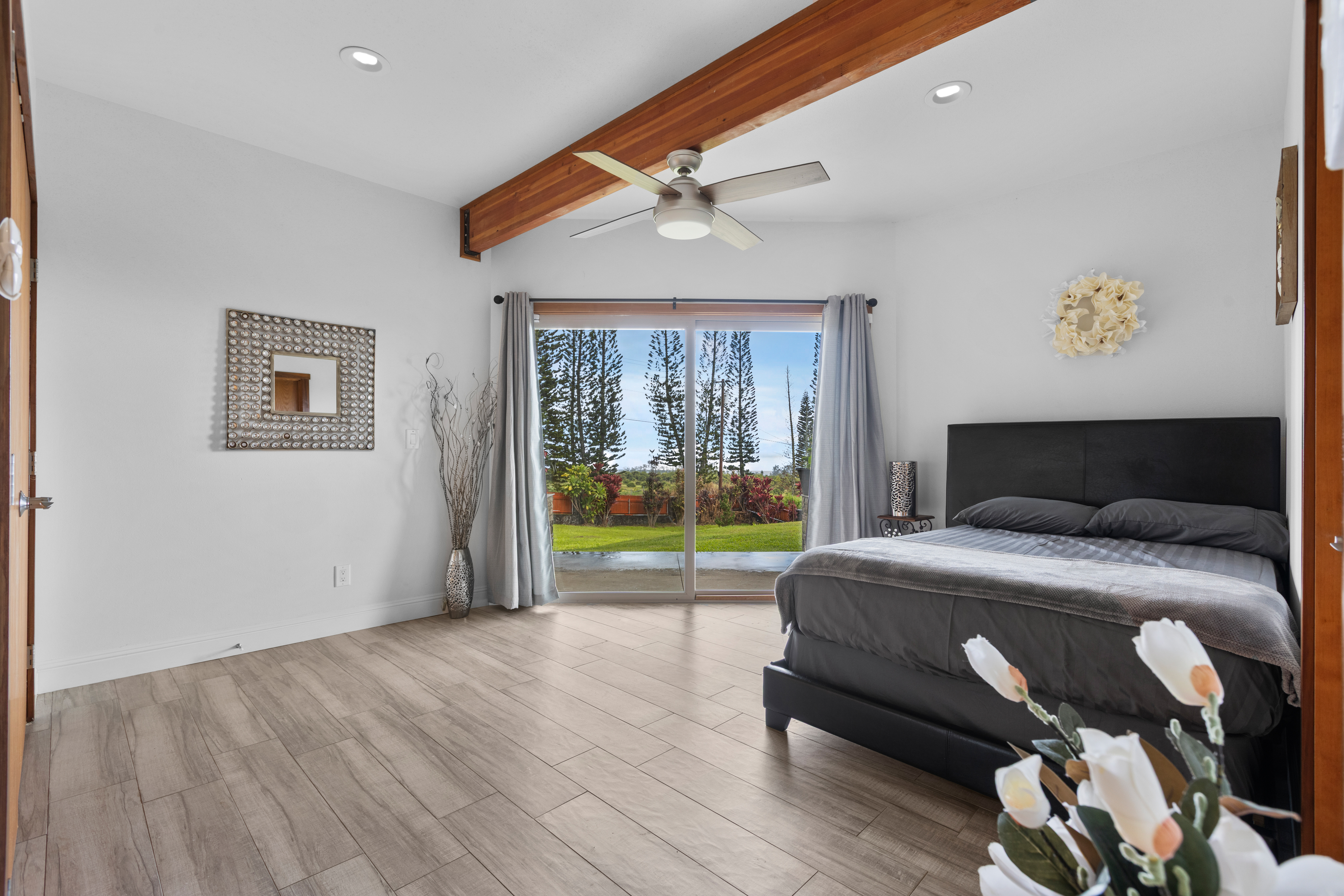 28-425 Overpass Road Pepeekeo, HI 96783 - Photo 23 of 30 a bedroom with a bed and glass window