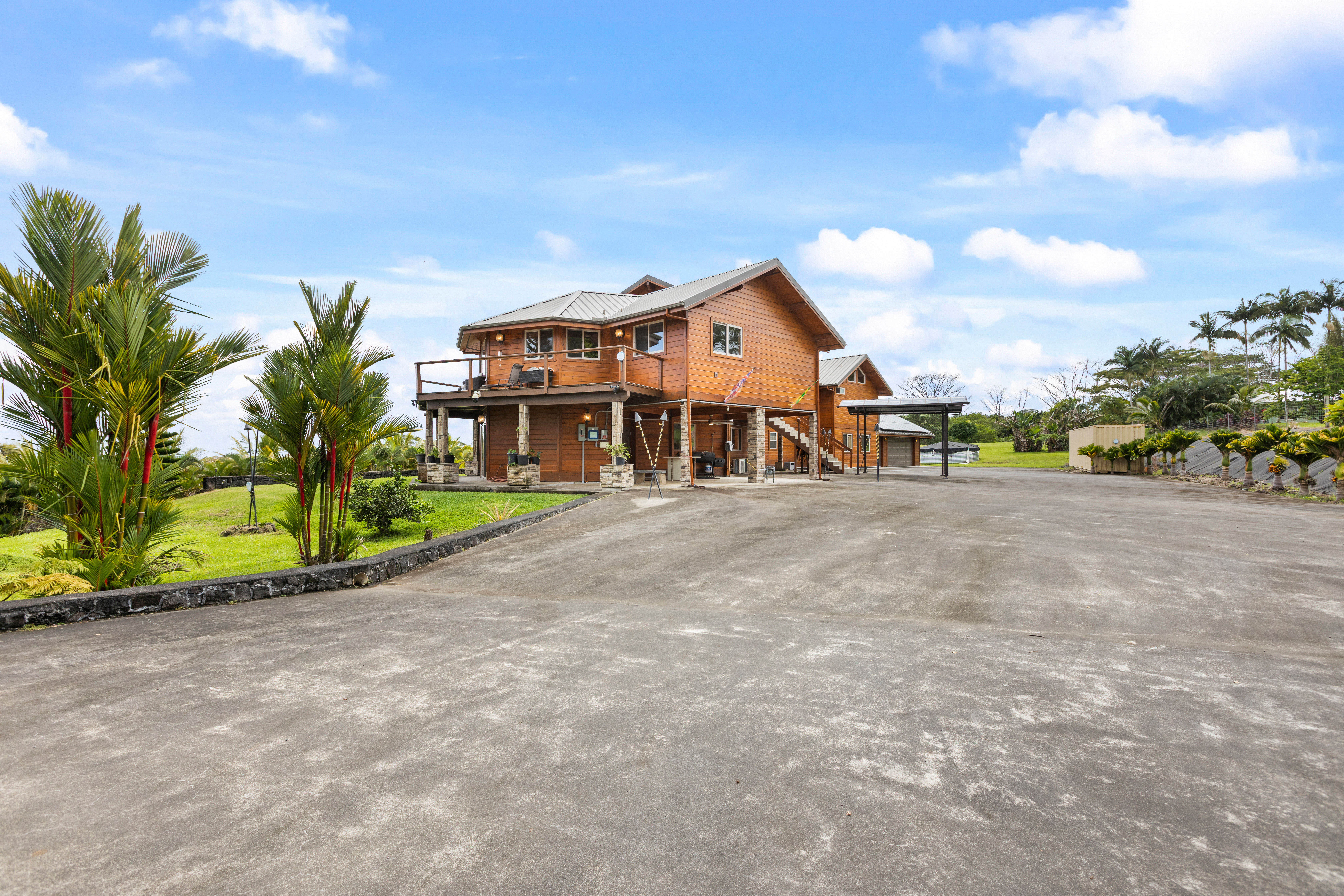 28-425 Overpass Road Pepeekeo, HI 96783 - Photo 24 of 30 a view of a house with a swimming pool and a yard
