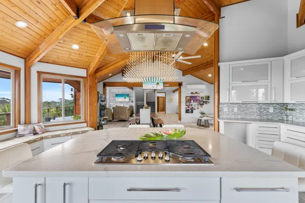 a kitchen with stainless steel appliances granite countertop a sink a stove and cabinets