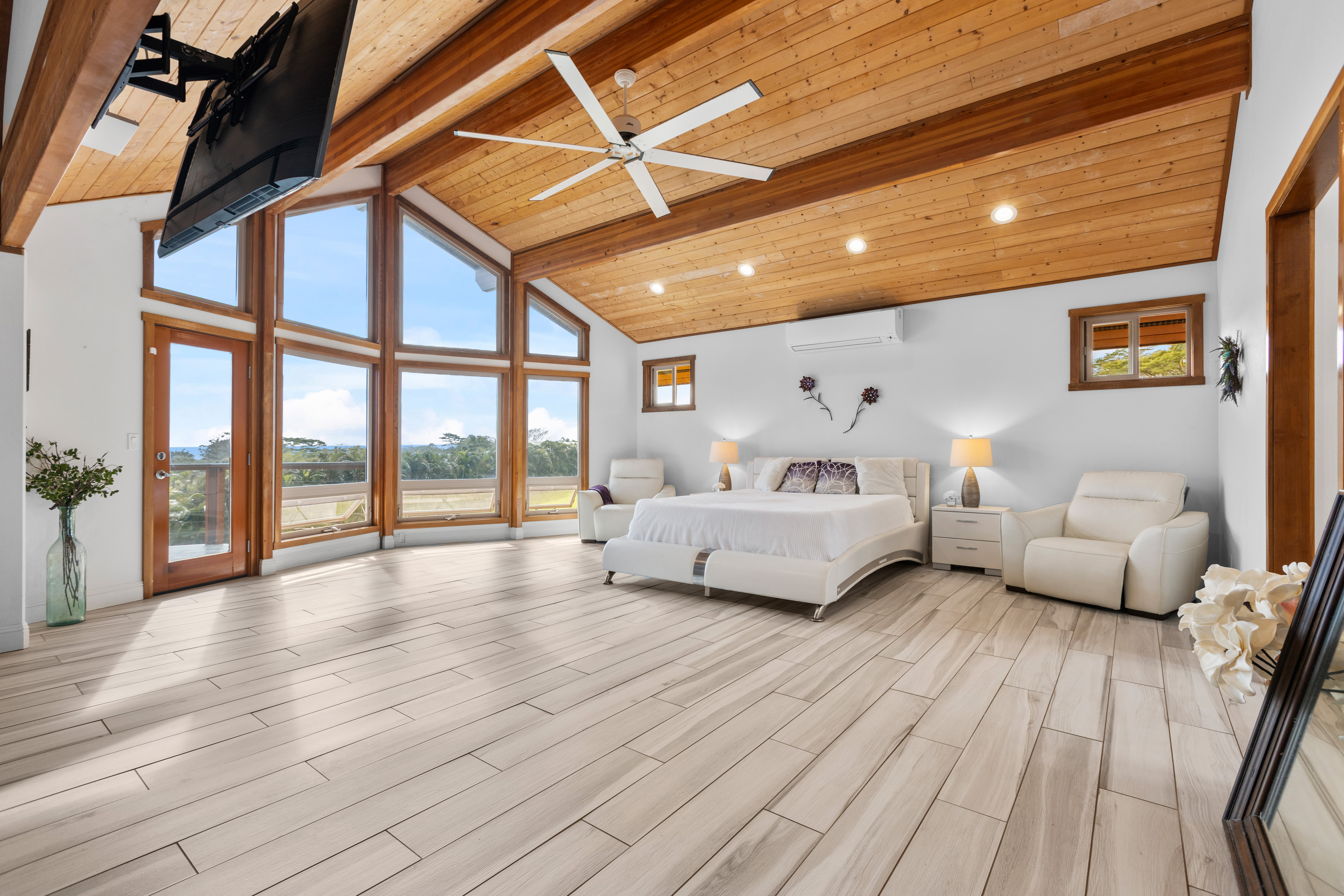 28-425 Overpass Road Pepeekeo, HI 96783 - Photo 9 of 30 a spacious bedroom with a bed and a large window