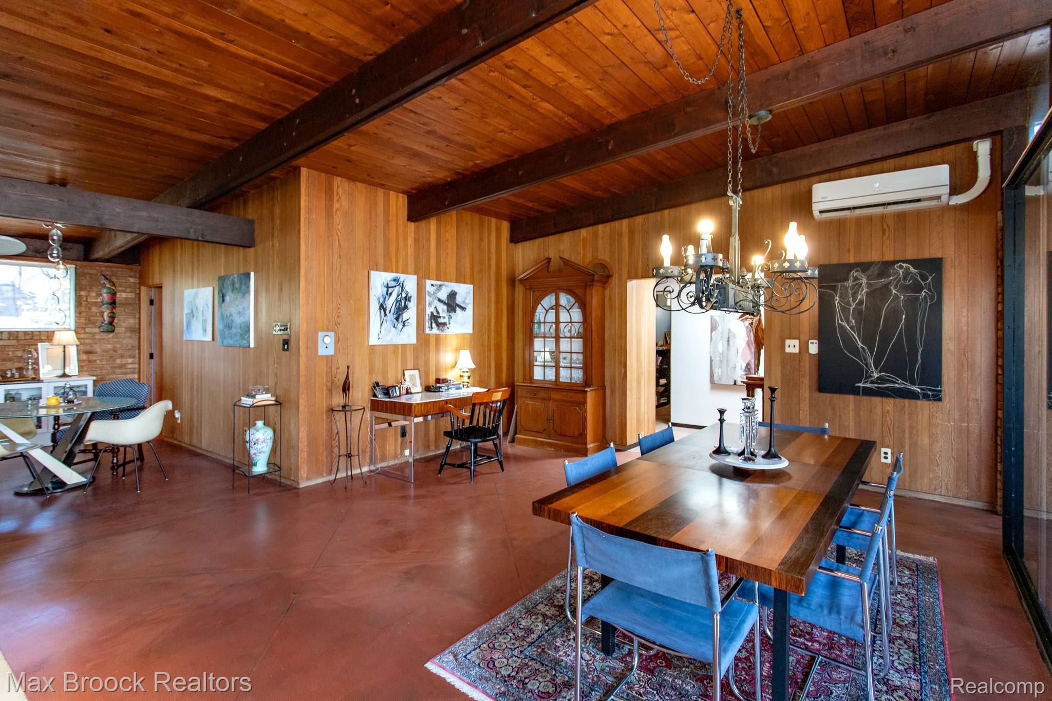 30875 Franklin Road Franklin, MI 48025 - Photo 18 of 86 Dining area with wood walls, concrete floors, beamed ceiling, and hanging lights