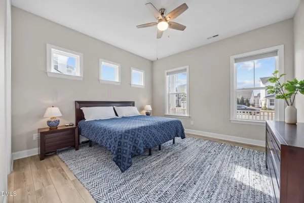 a spacious bedroom with a bed and a chair
