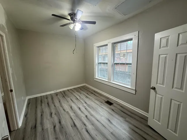 a kitchen with stainless steel appliances granite countertop a refrigerator sink and wooden cabinets