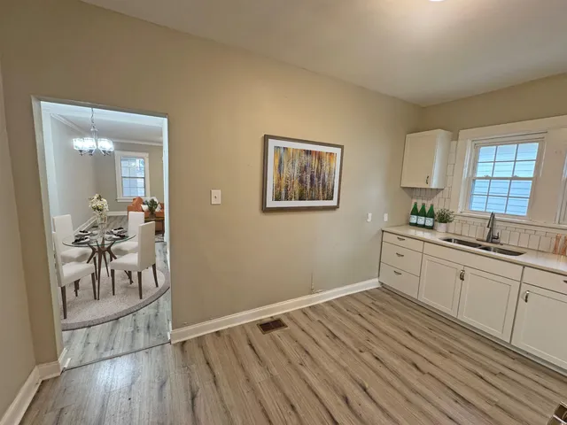 a kitchen with granite countertop a stove a sink and a refrigerator