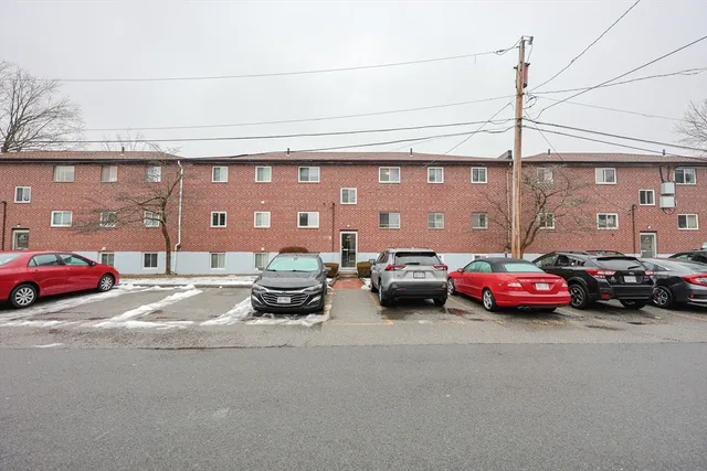 a view of a cars park in front of a building