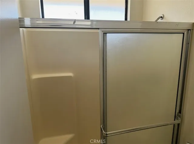 a en suite bathroom with a granite countertop sink and a mirror