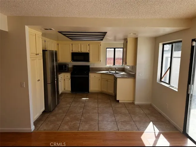 a kitchen with stainless steel appliances granite countertop a refrigerator and a stove