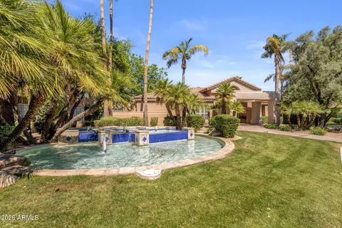 a view of a house with swimming pool and sitting area