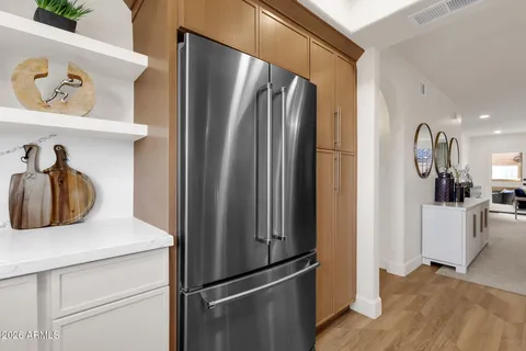 a kitchen with stainless steel appliances a refrigerator and cabinets