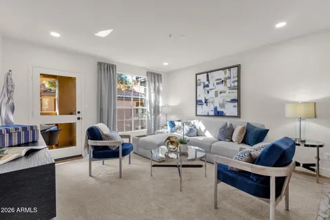 a living room with furniture and a lamp