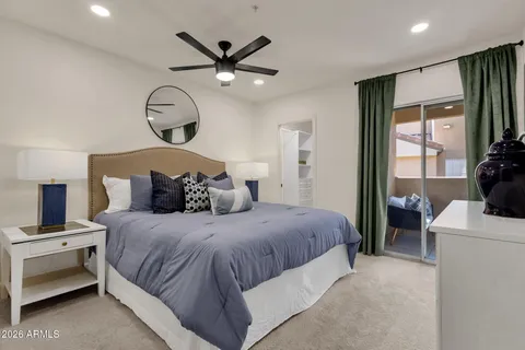 a bedroom with a large bed and a chandelier
