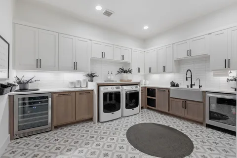 a kitchen with a stove sink and cabinets