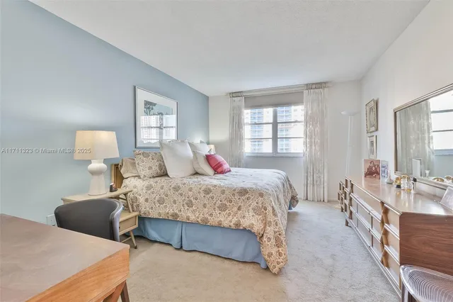 a bedroom with two beds and windows