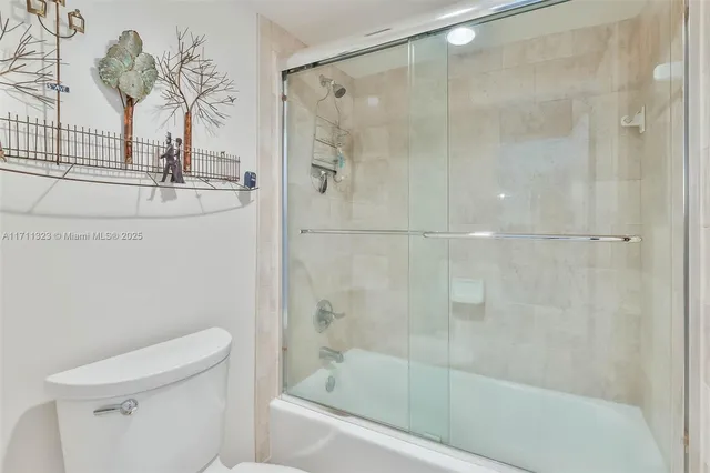 a bathroom with a shower and a toilet