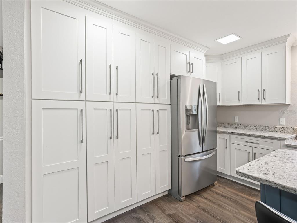 3505 Northeast 97th Street Road Anthony, FL 32617 - Photo 14 of 38 a kitchen with stainless steel appliances granite countertop a refrigerator sink and cabinets
