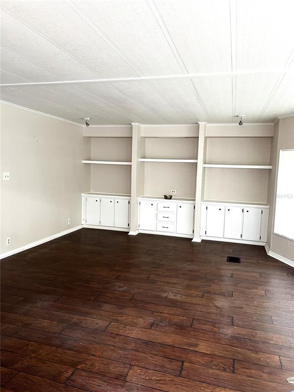 5030 Sydney Road Plant City, FL 33566 - Photo 16 of 23 a view of an empty room with a fireplace and wooden floor
