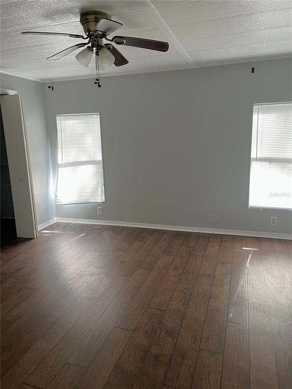 5030 Sydney Road Plant City, FL 33566 - Photo 19 of 23 an empty room with wooden floor fan and windows