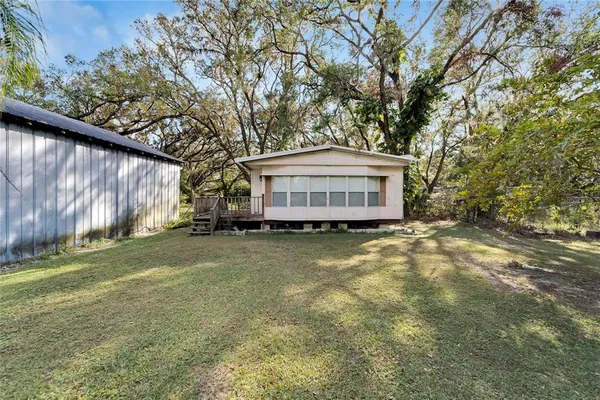 a view of a house with a yard and sitting area